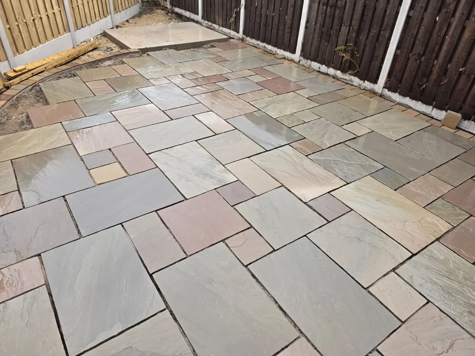 Newly laid natural stone patio paving installation in a private garden by Future Drainage and Groundwork LTD