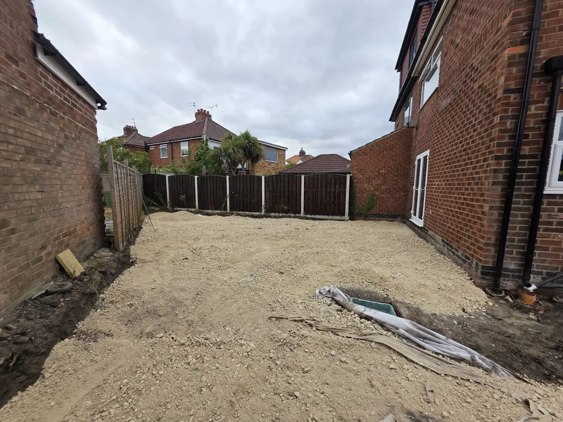 Groundwork sub-base preparation for a residential patio and driveway with integrated drainage in York